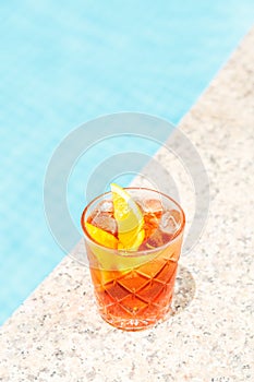 Negroni cocktail near a pool at the resort bar or suite patio. Luxury resort, vacation, room service concept