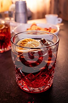 Negroni drink on a table in bar, alcoholic beverage with an orange garnish photo