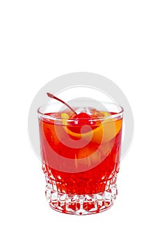Negroni. Red drink cocktail in glass jar with cherry and orange peel isolated