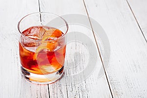 Negroni on a wooden board, white background