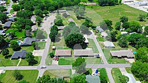 Neighborhood with cemetery in Checotah, McIntosh County, Oklahoma, row of single-family houses with large backyard lot size along photo