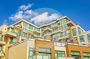 Neighborhood modern houses on sunny day in New Westminster BC. Canadian modern residential architecture