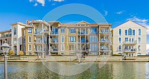 Neighborhood modern houses by waterfront on sunny day in BC, Canada. Canadian modern residential architecture