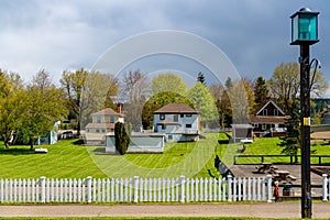 Neighborhood of typical small houses with green lawn in Port Gamble, Washington, USA