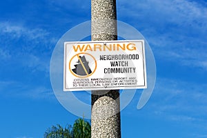 Neighborhood Watch Community warning sign in residential neighborhood. Blue sky