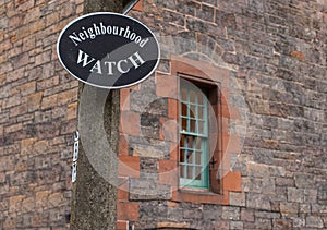 Neighborhood watch sign with window on the background