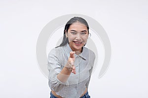 A neighborly young asian woman offers a handshake. A lady befriending someone. Isolated on a white background photo