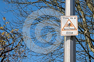 A neighbourhood watch scheme warning sign on a lamppost