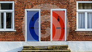 Neighbouring Terraced Houses With One Blue And One Red Front Door A