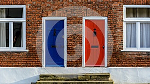 Neighbouring Terraced Houses With One Blue And One Red Front Door B