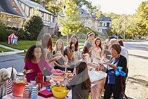 Neighbours helping themselves to food at a block party photo