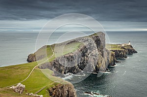 Neist Point lighthouse from Neist Cliff viewpoint with a dramatic colorful sky