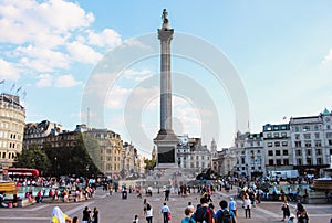 Nelson& x27;s column surrounded by crowds in the summer, Trafalgar Square, London, UK.