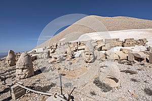 Nemrut ancient ruins statue heads on top of the mountain snowy day blue sky