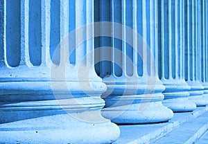 Neoclassical columns closeup blue - business concept