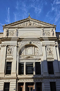 Neoclassical Courthouse Facade with Justice Sculpture, Street-Level View