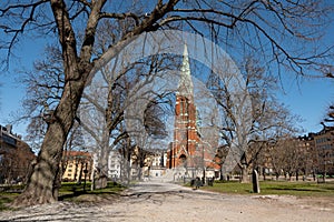 The neogothic Johannes Kyrka St Johns church in Stockholm, Sweden in a park photo