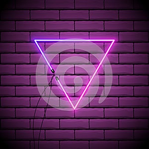 Neon abstract triangle. Glowing frame. Vintage electric symbol. Burning a pointer to a black wall in a club, bar or cafe. Design