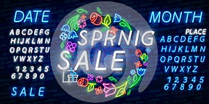 Neon alphabet and Spring Sale in flower frame over brick background. Spring sale, seasonal goods, store emblem. Spring concept.