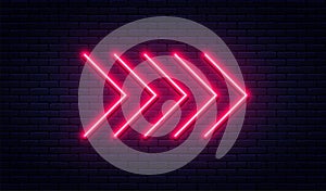 Neon arrow sign. Glowing neon arrow pointer on brick wall background. Retro signboard with bright neon tubes