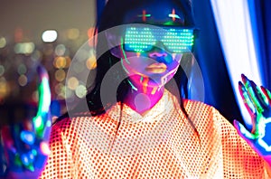 Neon  asian woman dancing. Fashion model woman in neon light, portrait of beautiful model with fluorescent make-up, Art and future