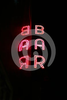 Neon bar sign with reflection