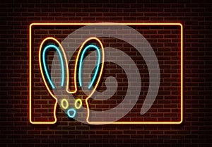 Neon color happy easter sign vector isolated on brick wall. Rabbit with frame light symbol, decorati