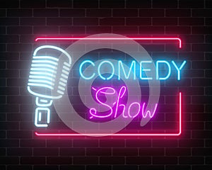 Neon comedy show sign with retro microphone on a brick wall background. Humor monolog glowing signboard.