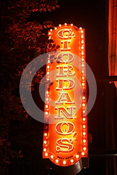 Neon Delight: Vibrant Pizzeria Sign Illuminating Chicago Night