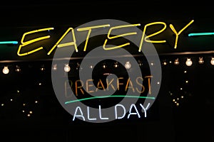 Neon Eatery and Breakfast All Day Sign on Restaurant