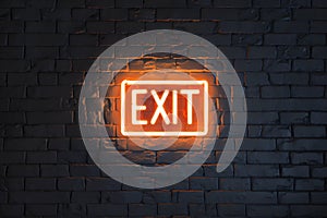 Neon EXIT sign on dark brick wall creates stark contrast, guides way out photo