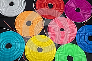 Neon flexible strip light. Flexible led tape neon flex in different colors on black background