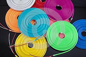 Neon flexible strip light. Flexible led tape neon flex in different colors on black background