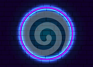 Neon frame is round on brick wall background.