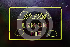 Neon Fresh Lemon Pie Sign in Rainy Window of Cafe