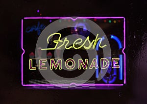Neon Fresh Lemonade Sign in Rainy Window