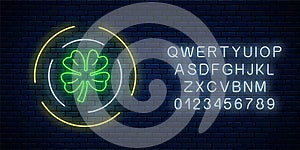 Neon glowing clover leaf sign in circle frames with alphabet. Green shamrock as Irish national holiday symbol