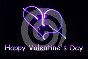 A neon glowing heart and an inscription happy Valentine`s Day on