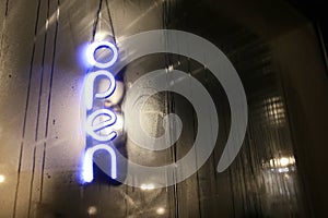 Neon Glowing Open Sign Hanging in Foggy Store Window on Winter Night