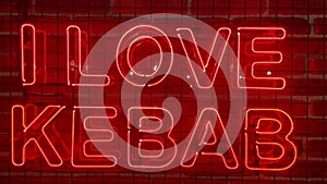 Neon glowing red sign on a brick wall with the inscription or slogan I love kebab. Brick wall, background. Bright