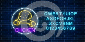 Neon glowing sign of chicken legs in circle frame with alphabet. Fastfood light billboard symbol. Cafe menu item.