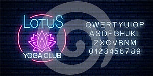 Neon glowing sign of lotus yoga club in circle frame with alphabet. Street lights signboard of chinese gymnastics