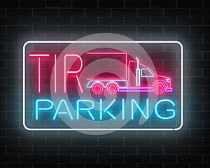 Neon glowing TIR parking sign on a brick wall background. Glow signboard of a long vehicle truck and truckers.