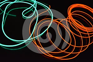 Neon green and red thin wire. Luminous wires, decoration and illumination of the surface. Electroluminescent wire, lighting object