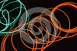 Neon green and red thin wire. Luminous wires, decoration and illumination of the surface. Electroluminescent wire, lighting object