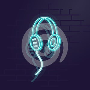 Neon headphones. Night illuminated wall street sign. Isolated geometric style illustration on brick wall background.