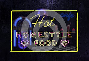 Neon Hot Homestyle Food Neon Sign in Rainy Window photo