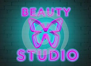 neon inscription beauty salon and butterfly on the background of a brick wall