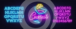 Neon lettering cocktails on brick wall background.