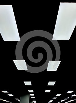 neon light against dark ceiling background.